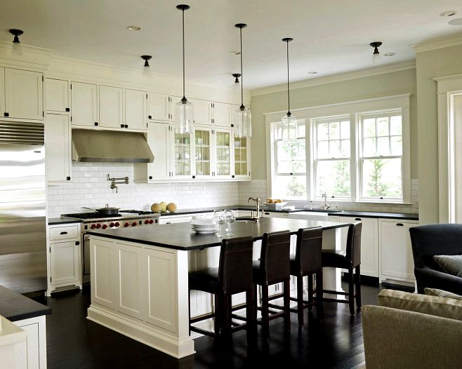 White kitchen cabinets painted benjamin Moore Cloud White, Ann sacks subway tiles backsplash, Rohl farmhouse sink, honed black granite countertop and Rohl faucet kit. off-white-kitchen-with-black-granite-countertop Susan Marinello Interiors